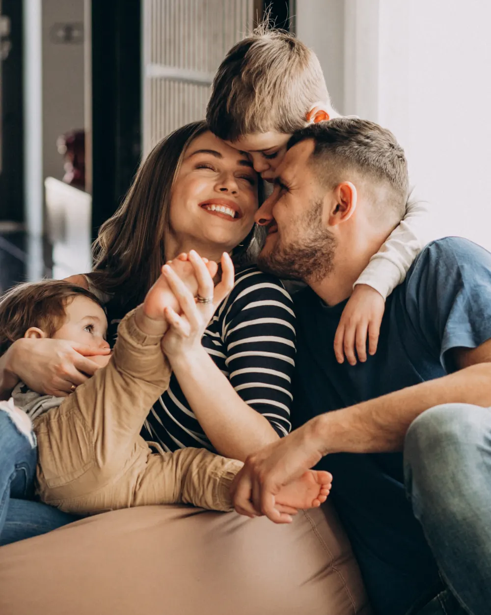 A young family laughing together at home